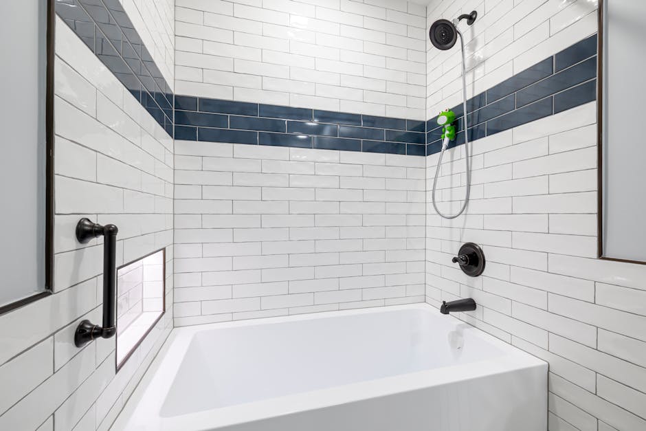 Sleek, minimalist bathroom with white and blue tiles and contemporary fixtures.